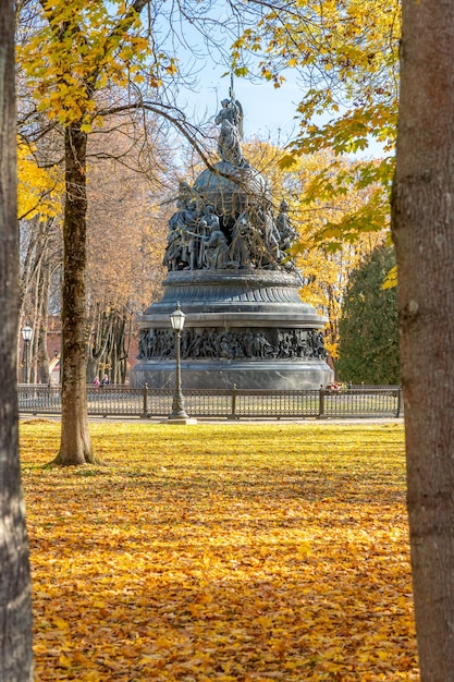 A statue of liberty stands in the park in autumn