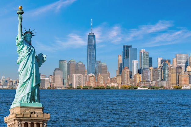 Photo the statue of liberty with manhattan city skyline background, landmarks of new york city, usa