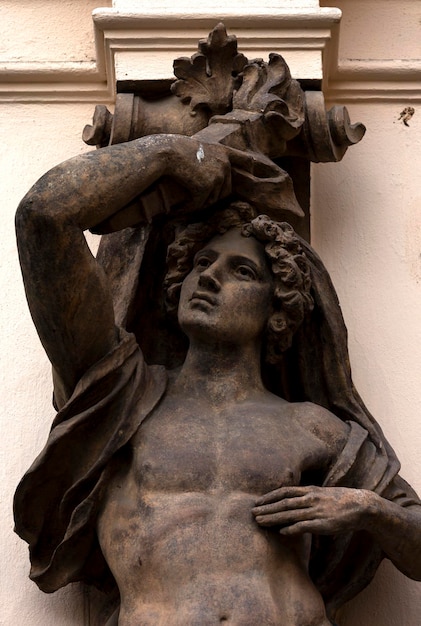 A statue of a man with a water pipe on his head