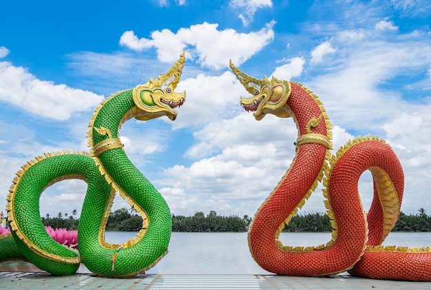 Statue naga mythology green red facing curve and blue sky in watsaman temple