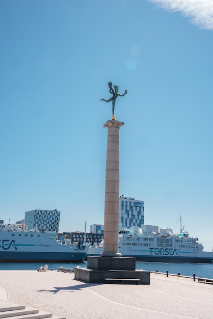 Statue overlooking the oresund with forsea ferry denmark or sweden