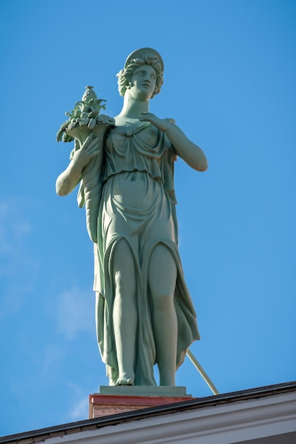 Statue of Roman goddess Ceres at the roof of Pushkin house in Saint Petersburg Russia