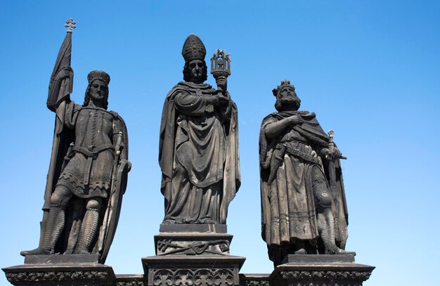 Statue of Saints Norbert Wenceslas and Sigismund for Czechia people and foreigner travelers visit at Charles Bridge crossing Vltava river on August 30 2017 in Prague Czech Republic