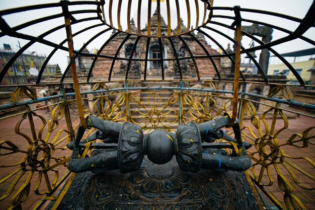 A statue of a woman is laying on a metal structure with the words " the word " on it ".