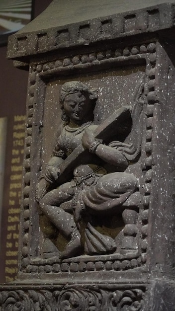 Statue of a woman playing the veena