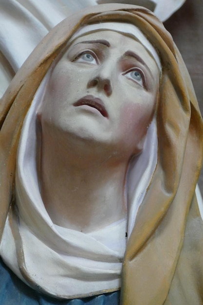 a statue of a woman with a cross on it