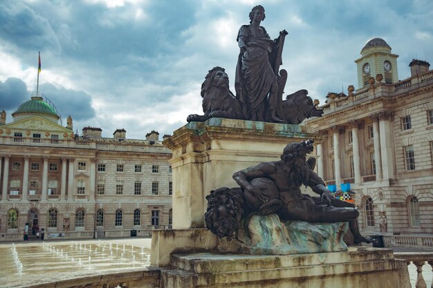 A statue of a woman with a lion on the top of it