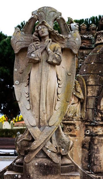 A statue of a woman with a shield on it