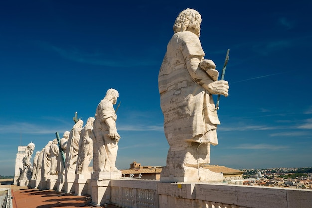 Statues of Christ and the apostles on the roof of St Peters basilica Vatican Rome Italy
