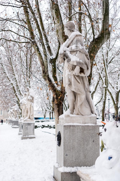 Statues covered by snow in the Plaza de Oriente in Madrid, on a cold winter day (selective focus).