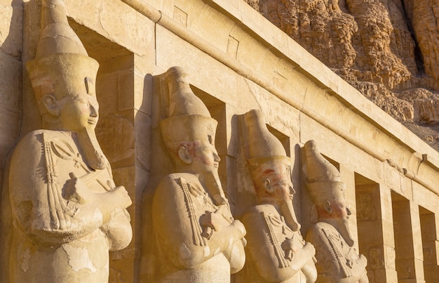 Statues of Hatshepsut Temple close up at sunrise