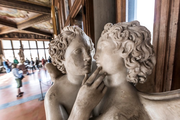 Statues and tourists in the Uffizi Gallery Florence Italy Eur