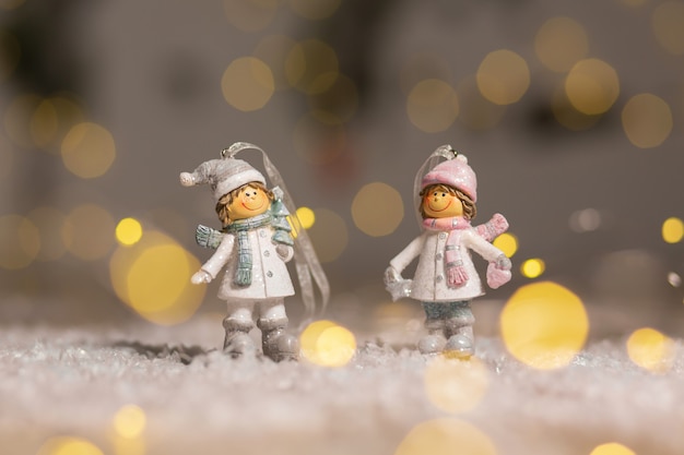 Statuette boy and girl in knitted hats and scarves