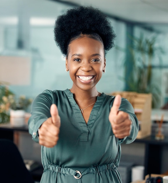 Stay dedicated and success will be yours Portrait of a young businesswoman showing thumbs up in an office