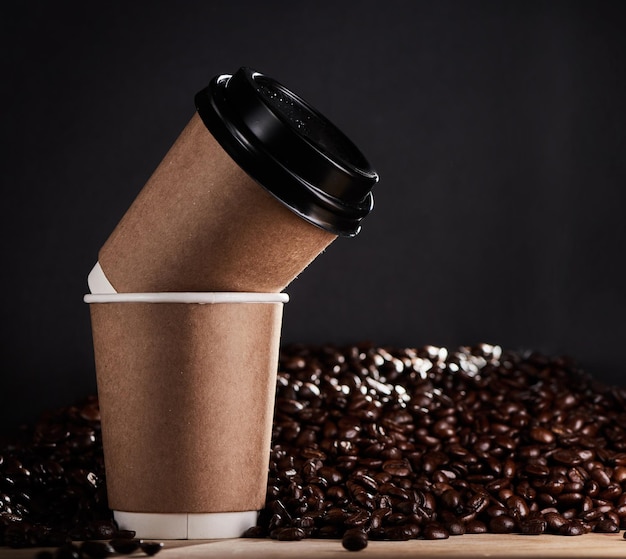 Stay grounded give warmth and share a latte love Closeup shot of two paper cups with coffee beans in the background