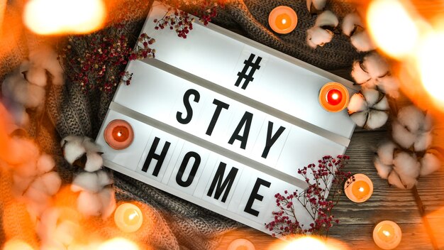 Stay at home Text in your light box with a background of sweater candles dried flower decoration