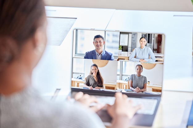 Photo staying connected with the team shot of an unrecognizable businesswoman on a videocall at work