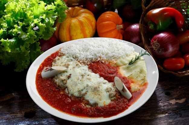 The steak parmigiana with potato and rice