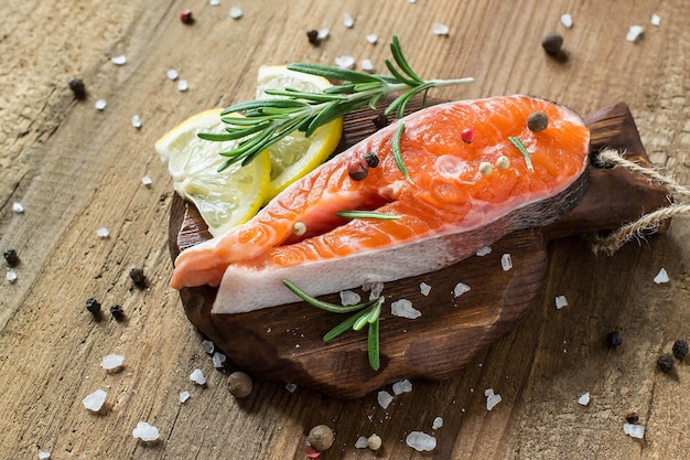 Steak of raw fresh salmon and ingredients for cooking