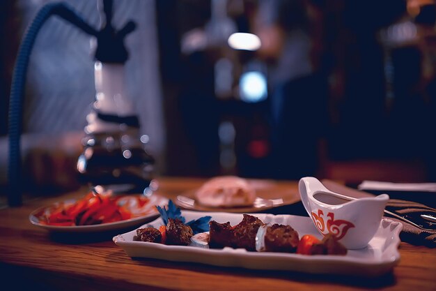 steak in the restaurant on the table / dinner in the restaurant, meat on the plate, served steak and cutlery