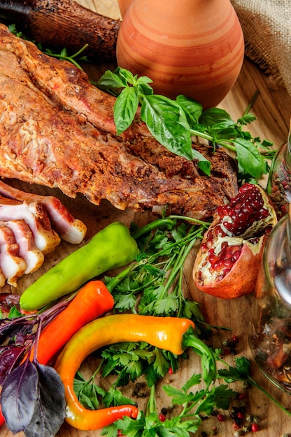 Steak on ribs,baked and served with color chili pepper. Wooden rustic background. Top view.