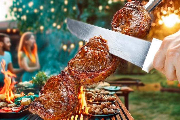 Photo steak rotisserie at the steakhouse sliced picanha picanha