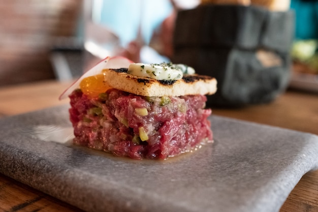 Steak tartar with creamy yolk and toasted brioche with sage butter and wine