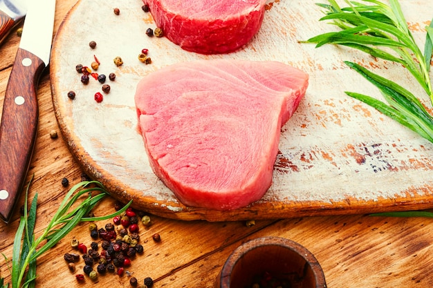 Steak of tuna fish on wooden table