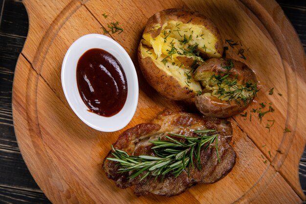 Steak with baked potatoes