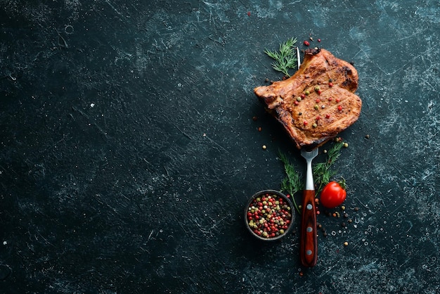 Steak with bone on a fork Barbecue menu Top view