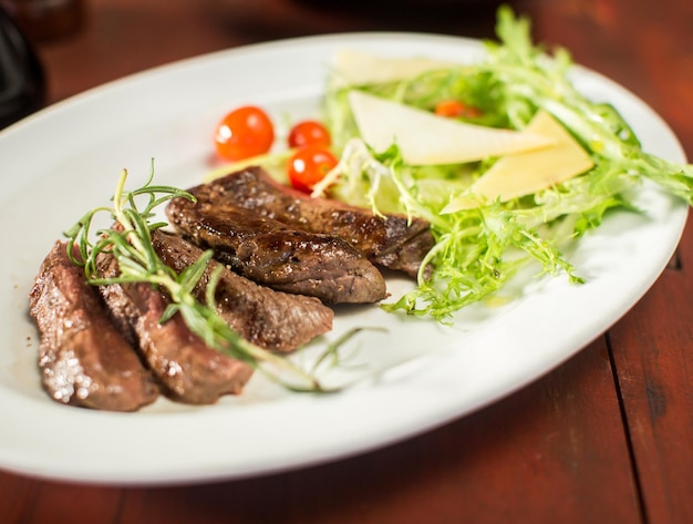 Steak with cheese and vegetables in a restaurant