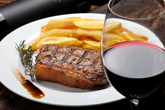 Steak with fries and red wine