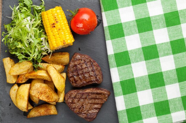 Steak with grilled potato corn salad and tomato