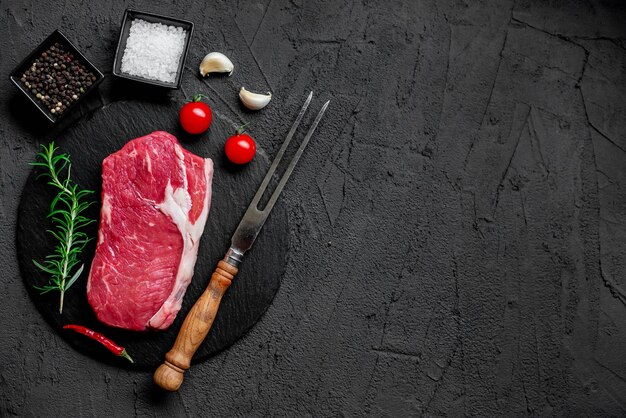 A steak with a knife and a knife on a black background