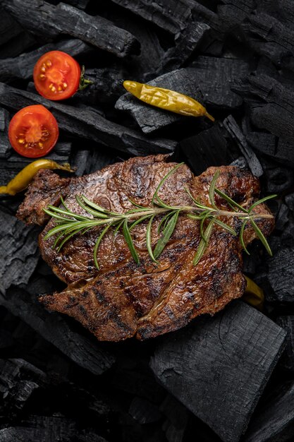 A steak with a rosemary sprig on it