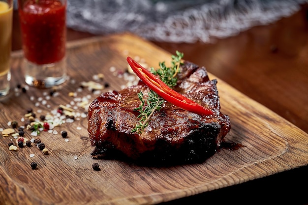 Steak with vegetable garnish on a black board. Close-up, selective focus