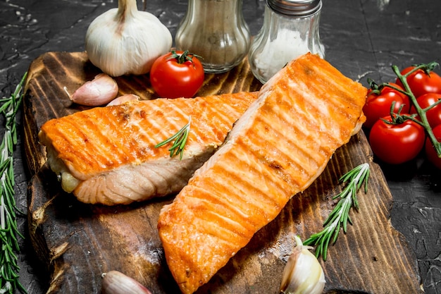 Steaks grilled salmon with spices and tomatoes