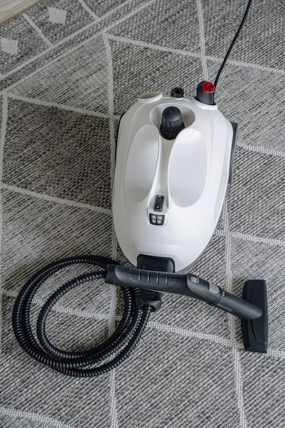 Steam cleaner on the carpet