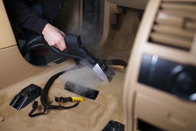 Steam cleaning a car floor