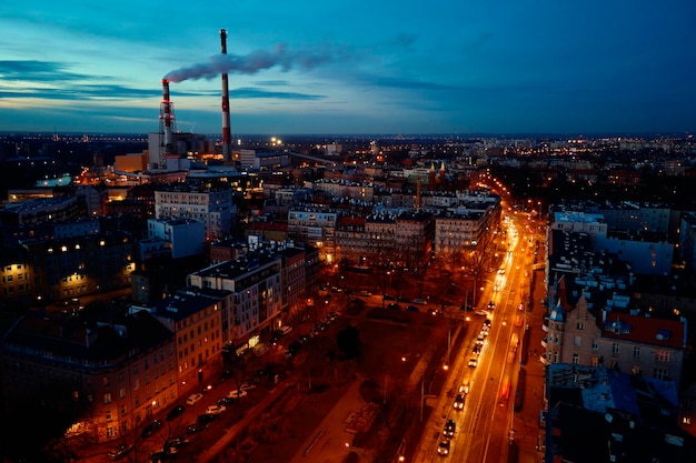 Steam from pipes over night city aerial view