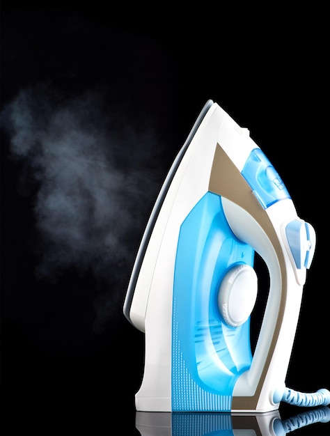 Steam iron on a black background