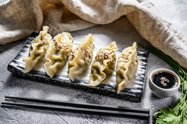 Steam Korean dumplings on a ceramic plate.  