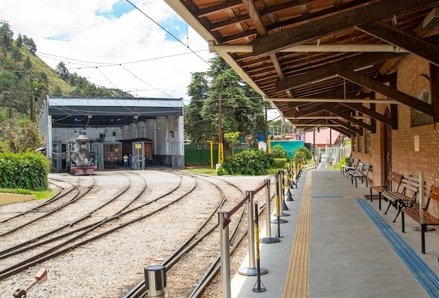 Steam train at Emilio Ribas Station and view of train tracks and platform in Campos do Jordao Brazil