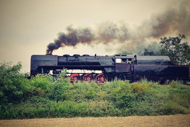 a steam train is going down the track with the word steam on the front.