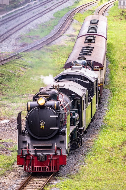 Steam train locomotive approaching a station.