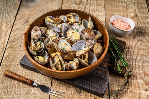 Steamed cooked shells Clams vongole in a wooden plate