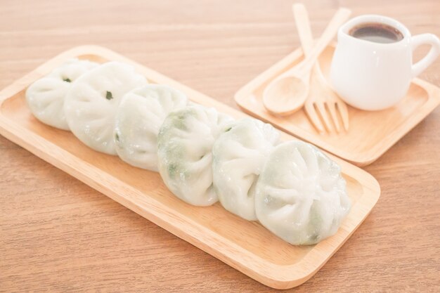 Steamed dumpling stuff serving on wooden plate