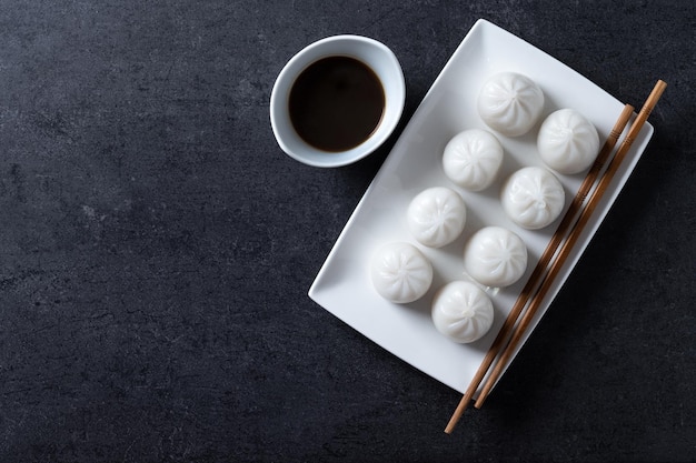 Steamed dumplings on black slate background