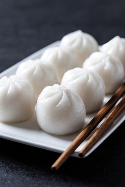 Steamed dumplings on black slate background