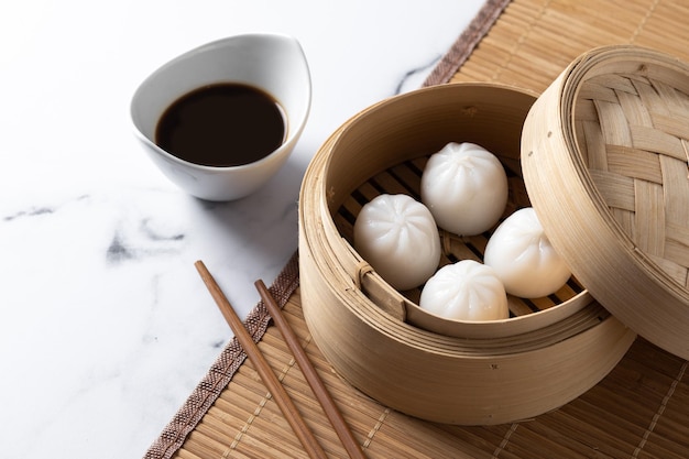 Steamed dumplings on white marble background Traditional oriental food